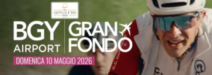 Primo piano di un ciclista con una divisa sportiva e occhiali da sole tecnici e, in sovraimpressione, logo della gara Granfondo BGY Airport
